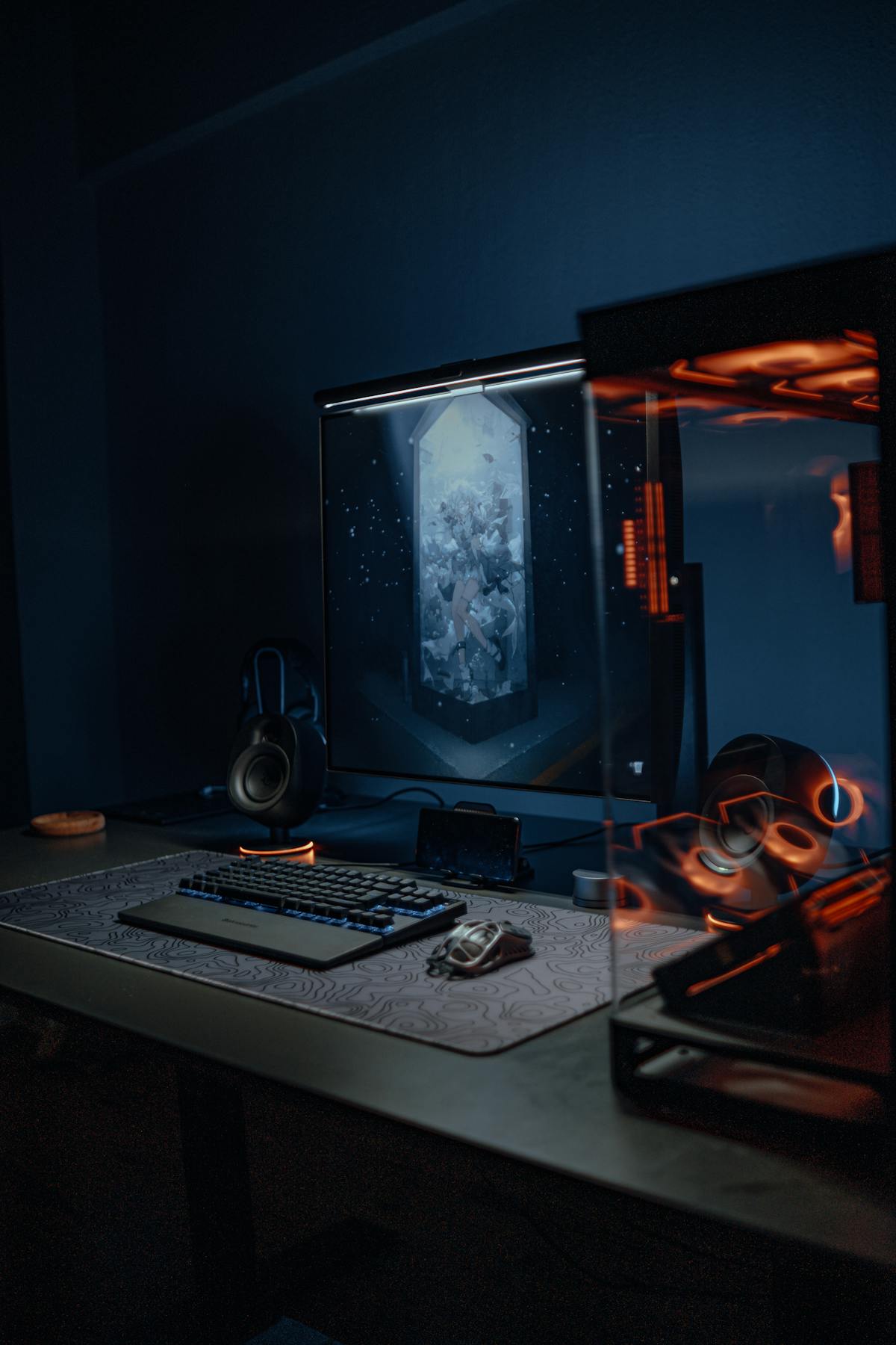 Dark gaming room setup with RGB monitor lighting